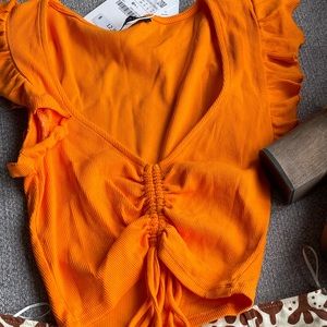 NWT. Zara size small orange crop top.